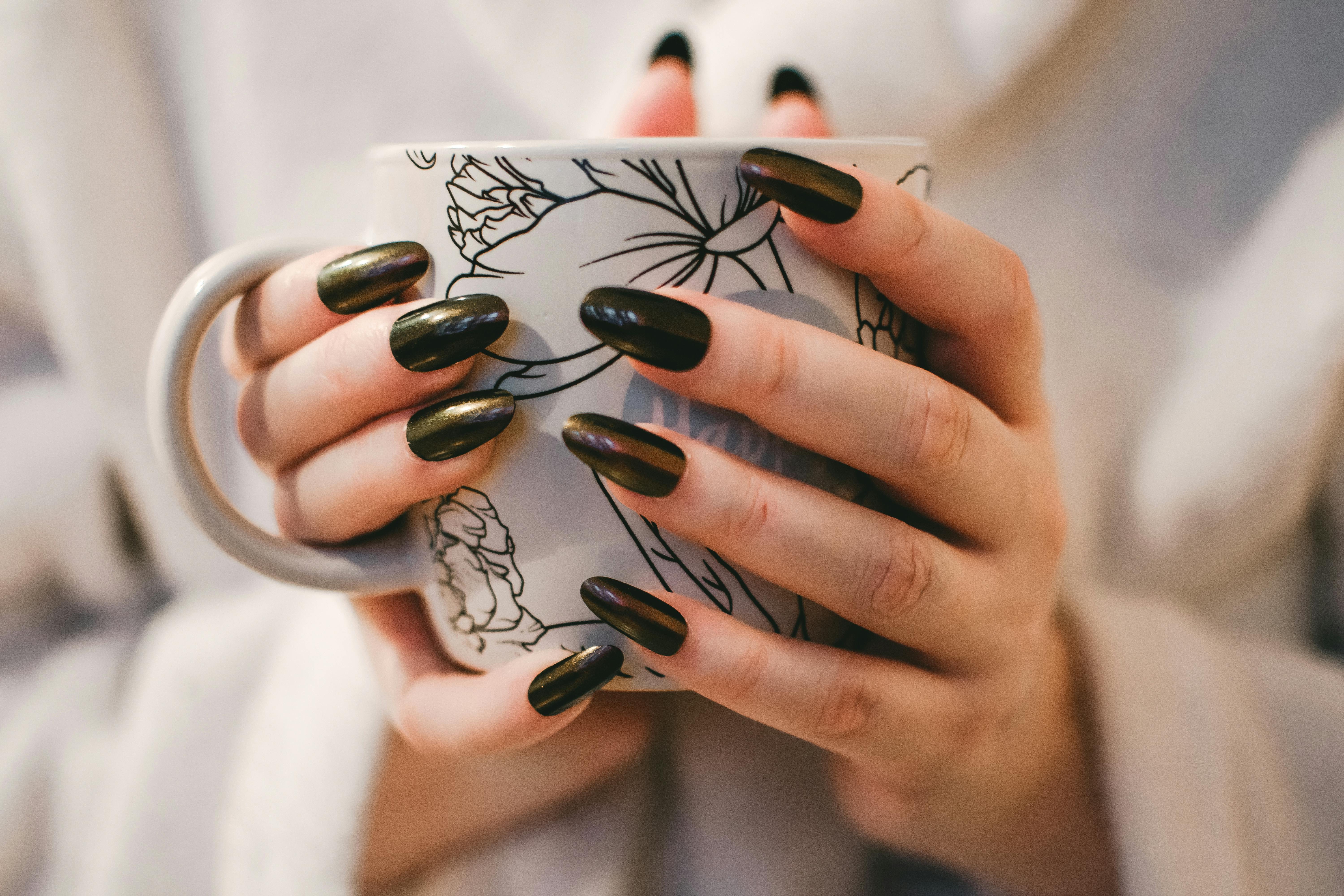Black manicure holding a ceramic cup - modern styling