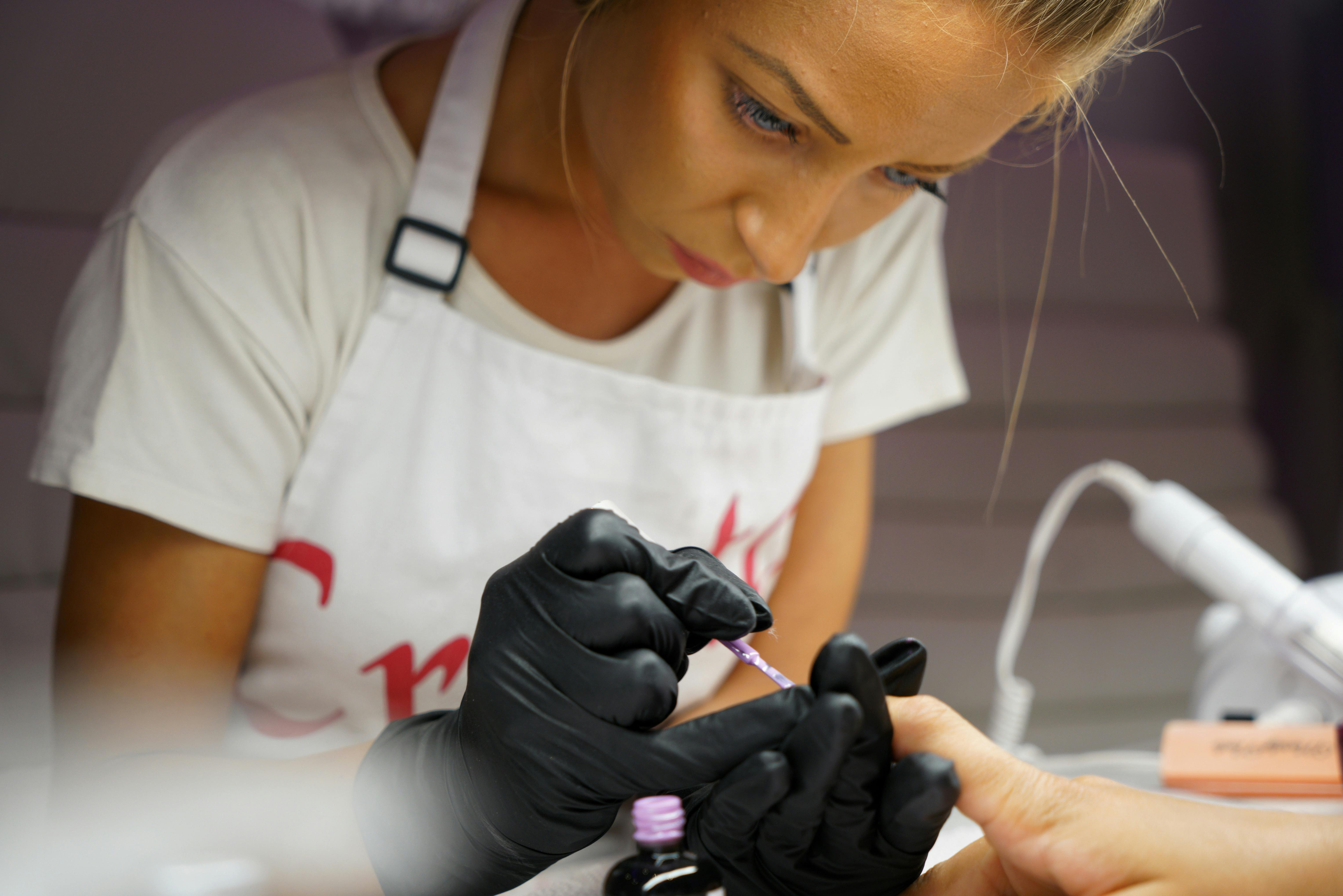 Manicurist applying detailed nail art (close-up) - Great Yarmouth